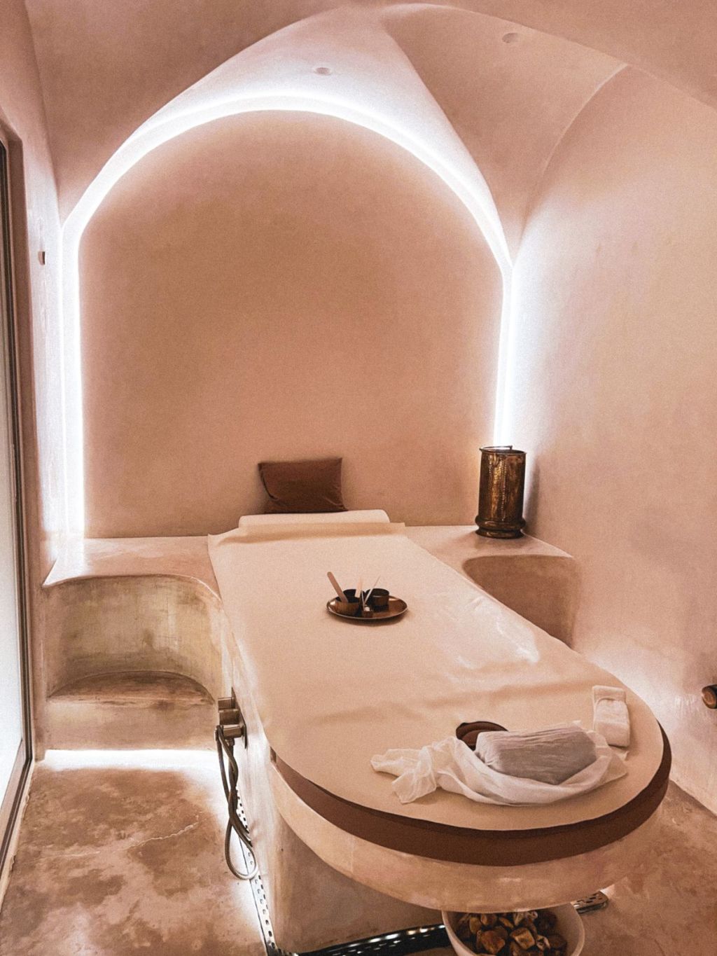 Minimalist luxury spa treatment room with ambient lighting.